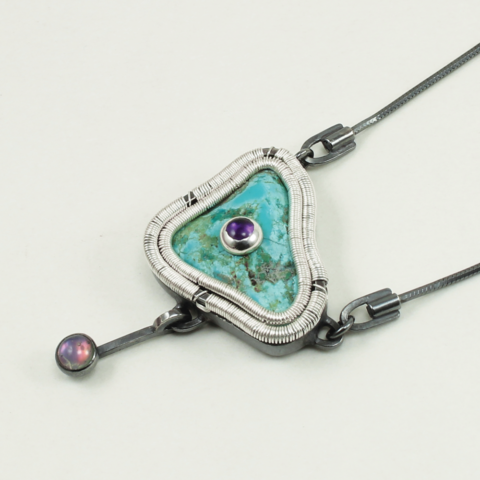 Angle shot of Jack Boglioli art jewelry pendant Raw Turquoise Pendant with Amethyst and Black Mother of Pearl