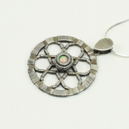 Angle shot of geometric pendant by Jack Boglioli with ethiopian opal