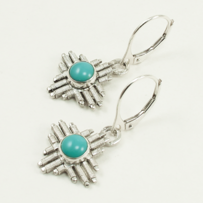 Angle shot of small Jack Boglioli Zia earrings from the New Mexico Collection with turquoise