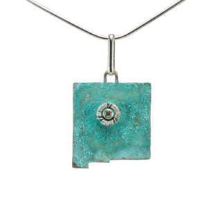 New Mexico State shaped pendant with white topaz and green patina